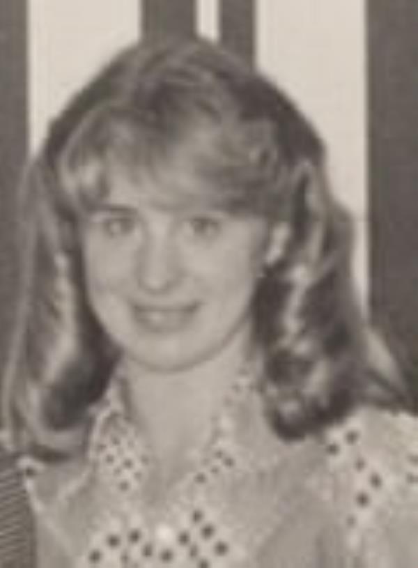 An old black-and-white photograph of a young woman with curly blond hair