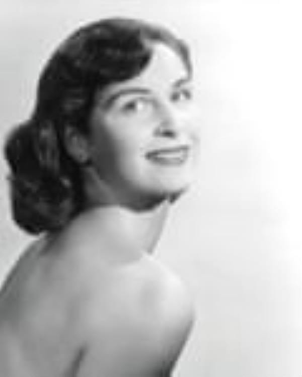 A black and white photograph of a young woman with dark brown hair and bare shoulders