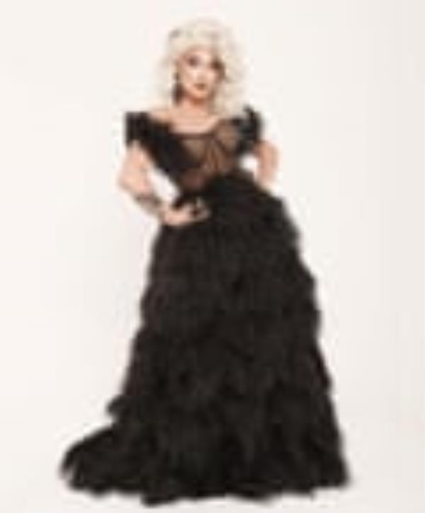 The Vivienne wearing a big blond wig and a black feather and mesh gown