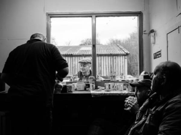 Dafydd Pughe (left) with his brother John (2nd left) and his son Alwyn (right) reading the results after a day scanning ewes for pregnancy.